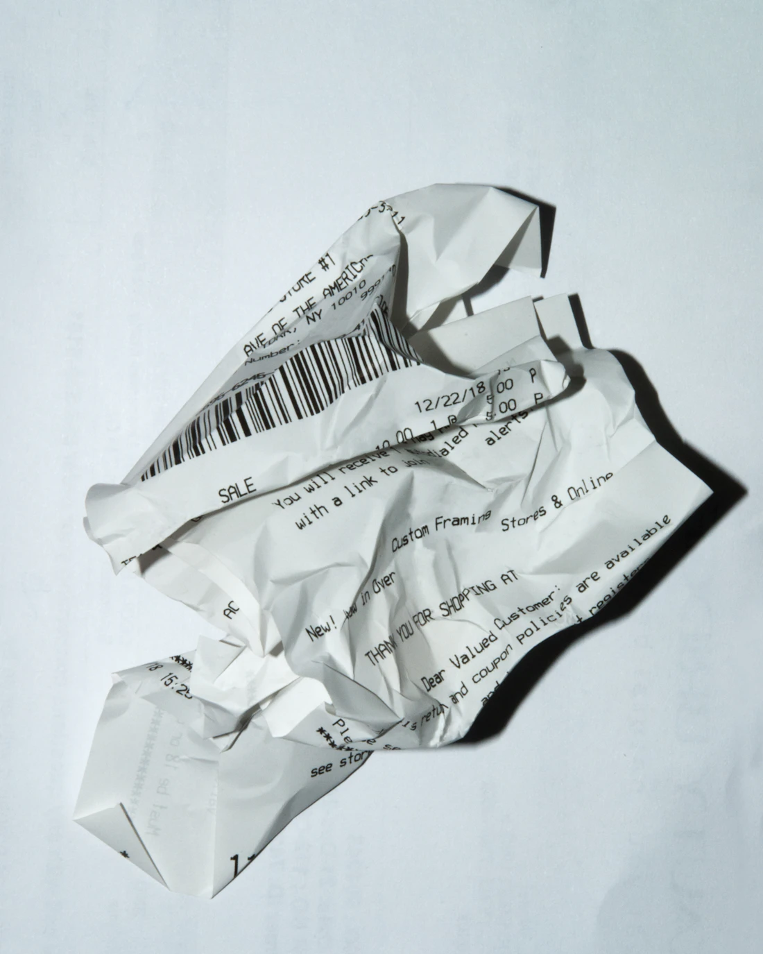 A long paper receipt on a white surface